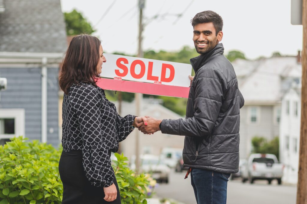 Realtor shaking hands with new home owner