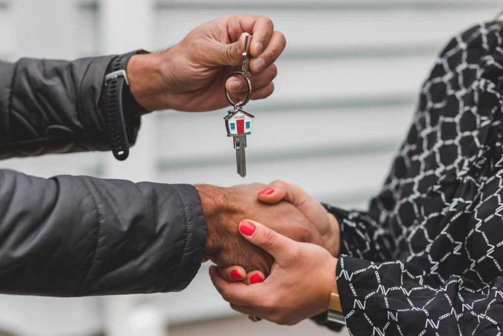 Realtor closing a deal by exchanging home keys