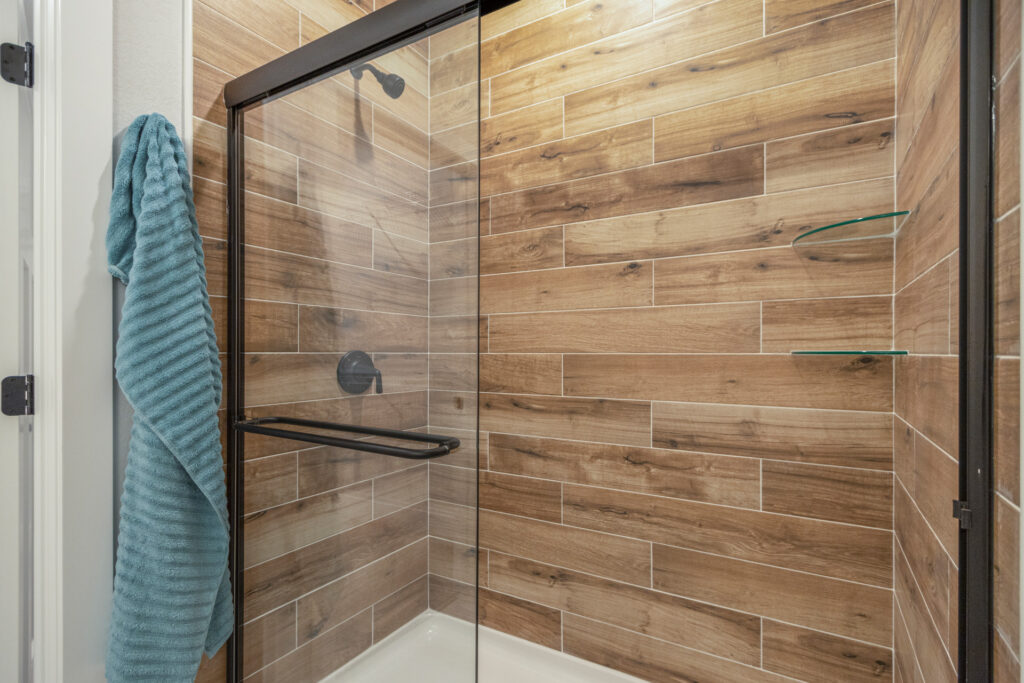 The Juniper Duplex Master Shower by Stepping Stone Homes