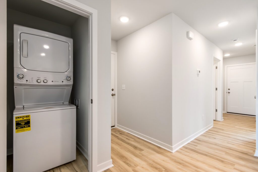 The Pine Laundry Closet by Stepping Stone Homes